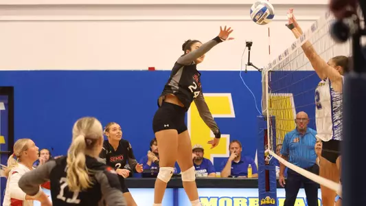 Alaina Lester high for the attack from the middle of the court