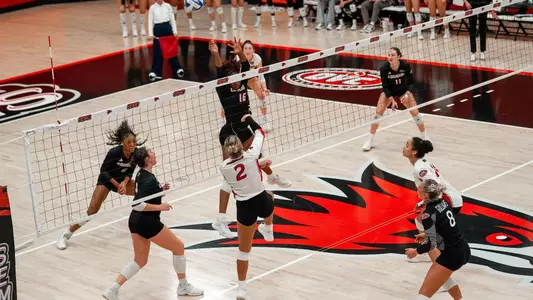 Lucy Arndy goes high over the block to score for the Redhawks
