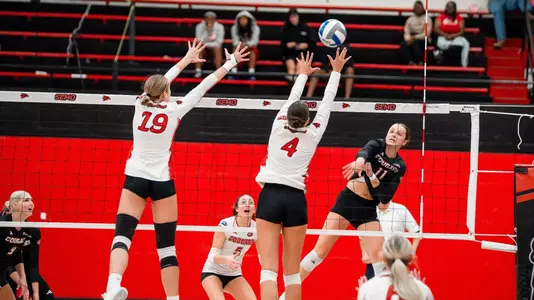 Marin Johnson and Jacey Young form the blocking wall against SIUE