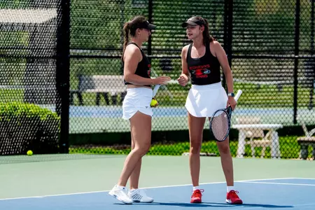 Maja Bajorek and Mia Mayerova discussing strategy during doubles match