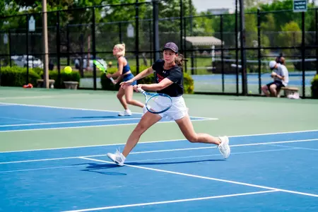 Sofia Zemtsova hitting a forehand on the run approaching the net