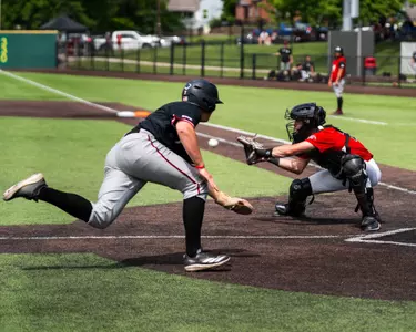 Tank Sims receives the ball and attempts to tag out a runner