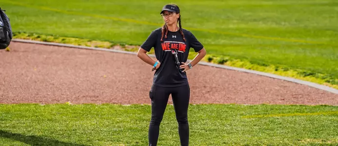 Coach Scott watches her athletes compete