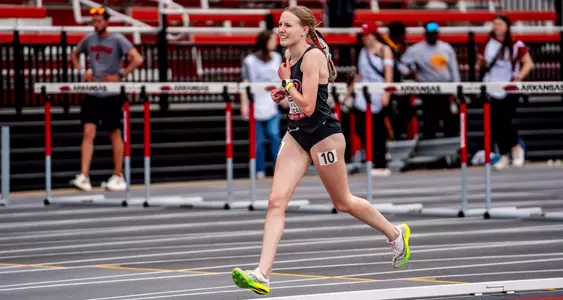 Layla Fliege runs hard while she finishes the steeplechase race