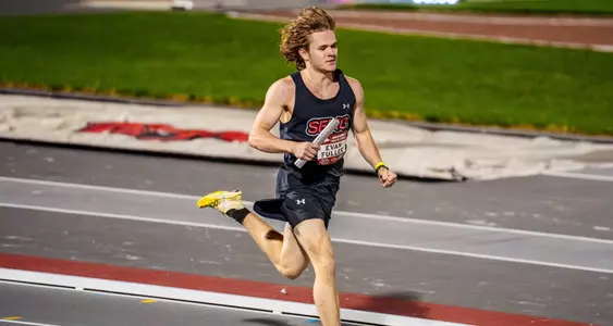Evan Fuller wraps up his leg of the relay on the back-straight