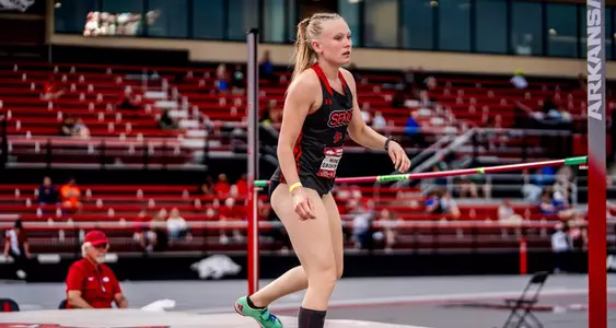 Molly Grohmann standing on the high jump landing area after clearing the bar