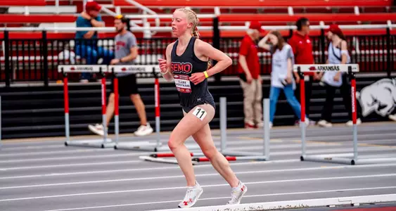Claire Horstmann wrapping up her distance race running toward the finish line