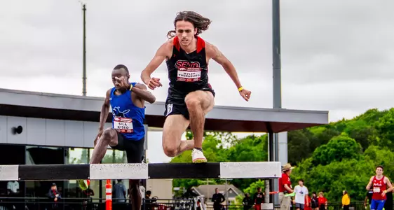 Myles Thornburg clears the hurdle in the steeplechase