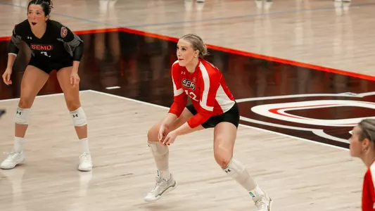 Reagan Nelson eying down a serve and ready for a dig