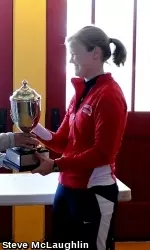 Varsity Eight boat coxswain Alex Thornton receives the Kittell Cup from Syracuse.