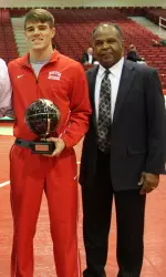 Senior Eric Des Lauriers (left of head coach Carl Adams) earned his second pin of the season at 174.