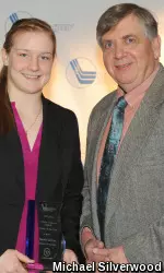 Lefort presented with her Player of the Year Award by Hockey East Commissioner Joe Bertagna.