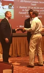 Head coach Ryan Polley and Director of Lacrosse Operations Al Lattell present Sam Talkow with the team's Ground Ball Award during Saturday's banquet.