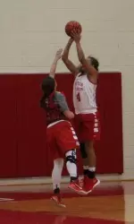 Freshman Payton Hauck shoots a jumper over Sarah Hope