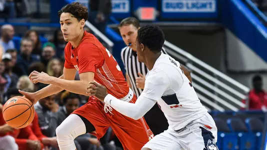 Javante McCoy dribbles around UConn defender
