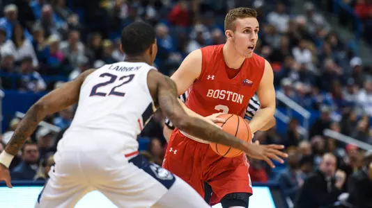 Tyler Scanlon looks to his left to make a pass at UConn