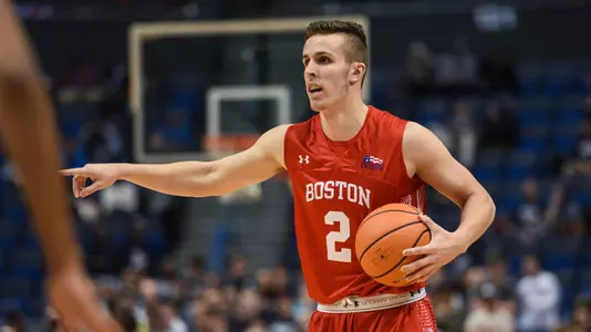 Tyler Scanlon handles the ball and points left at UConn