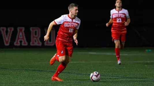 Toti Knutsson brings the ball up the field with David Riccio behind him at Harvard.