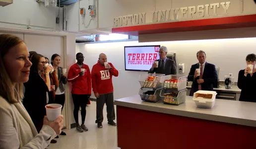 Several BU dignitaries are having a toast using smoothies in honor of the opening of the Terrier Fueling Station
