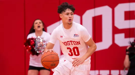 Javante McCoy dribbles the ball up the court against Vermont.