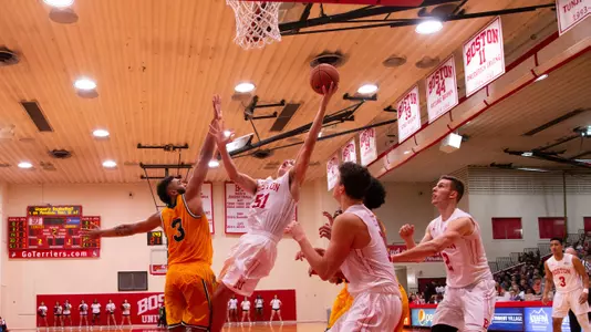 Max Mahoney attempts a layup while being defended by Vermont defenders at Case Gym.
