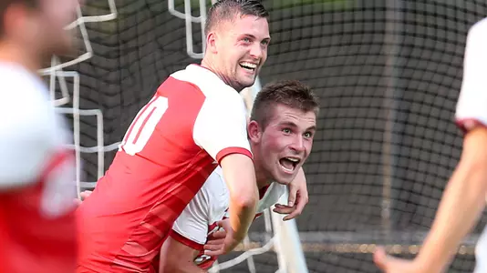 Matt McDonnell is hugged from behind by Toti Knutsson while running and celebration his goal scored at Boston College.
