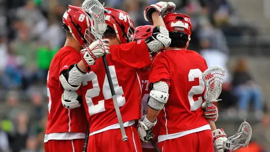 The men's lacrosse team celebrates a goal