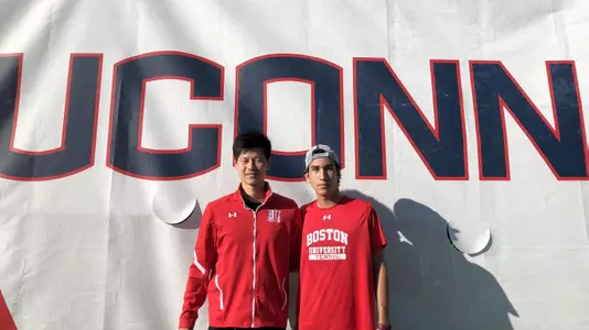 Owen Lu and Max Stehling pose for a photo in front of a UConn banner after winning the Doubles Flight A title.