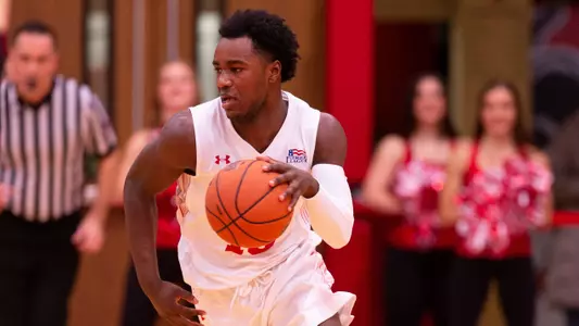 Jonas Harper brings the ball up the court against Vermont.