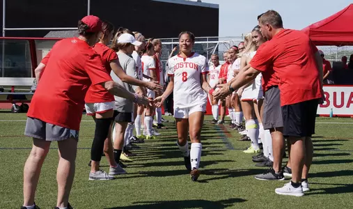 Marli Rajacich high fives teammates.