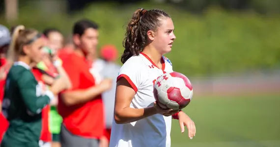Kayla Ross holds the ball on the sideline.