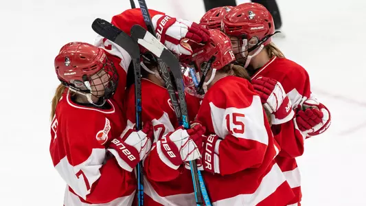 Boston University women's ice hockey players celebrate a goal against Providence