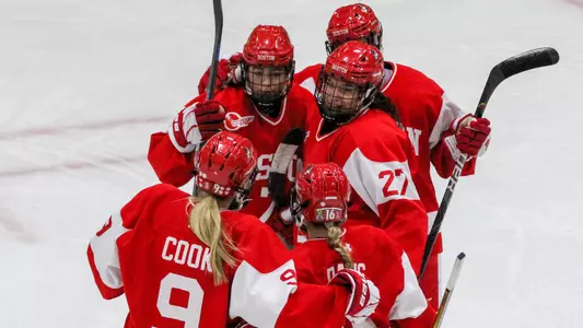 The BU women's ice hockey team celebrates a goal at Vermont