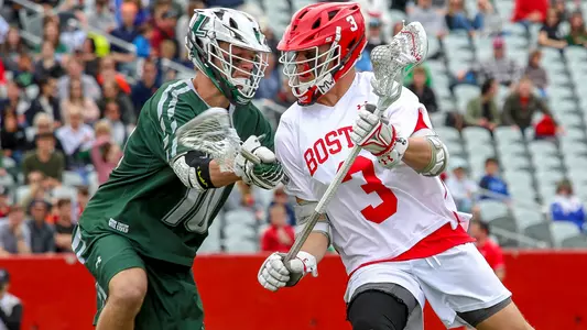 Jett Dziama of the men's lacrosse team is defended by a Loyola Maryland player