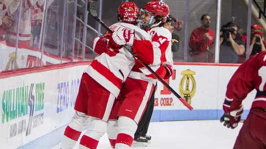 Patrick Curry and Ethan Phillips celebrate a goal in the men's ice hockey team's 5-2 win over Harvard