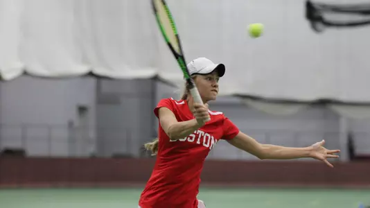 Katya Martens goes for the volley at the net.
