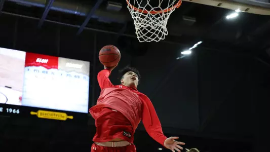 Fletcher Tynen goes for a warmup dunk at Elon.