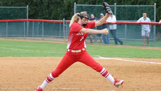 Emily Gant is in wind-up motion before throwing pitch.