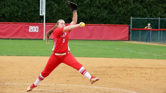 Ali DuBois is in full windup on a pitch at home