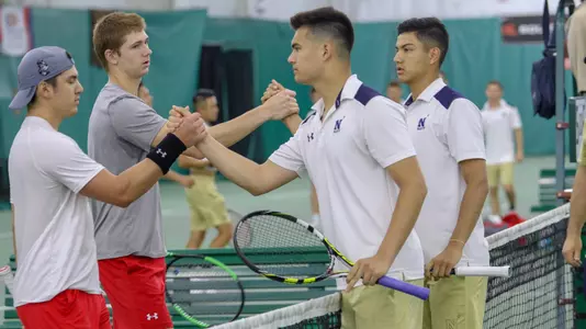Men's Tennis handshake at the net with Navy