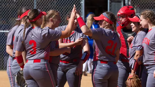 DuBois and the defense are met up by the rest of the team after earning a third out. There's high fiving taking place.