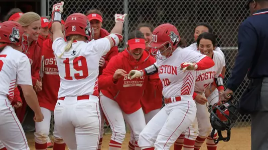 Aliyah Huerta-Leipner is greeted at home by teammates following a homer vs. Army.