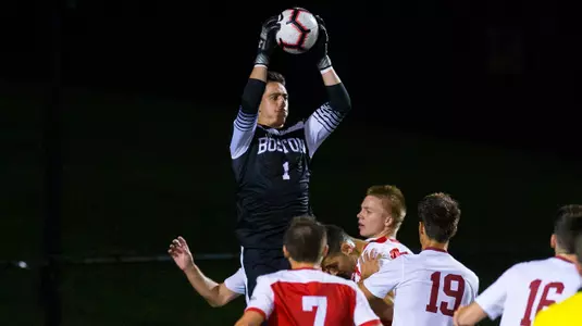 Mike Bernardi jump up into the air to snag the soccer ball.