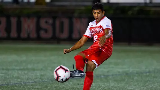 Mana Chavali kicks the ball downfield.
