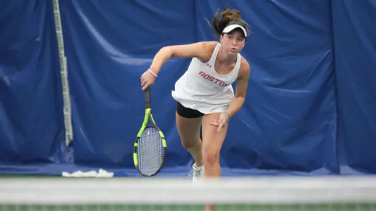 Erica Di Battista follows through on a serve with racquet
