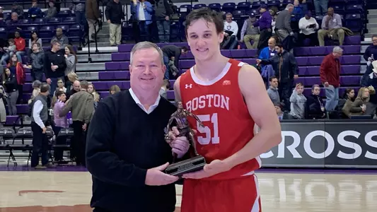 Max Mahoney receives the Homecoming MVP award at Holy Cross at mid court.