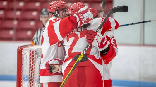 The women's ice hockey team celebrates a goal