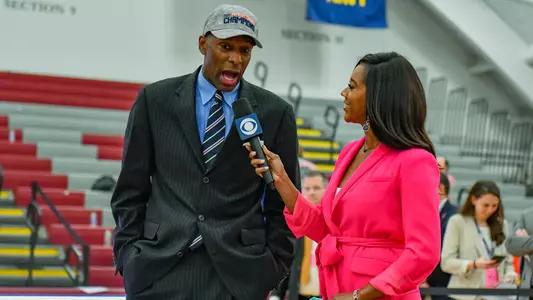 Joe Jones conducts an interview after winning the Patriot League championship with the CBS Sports Network reporter.