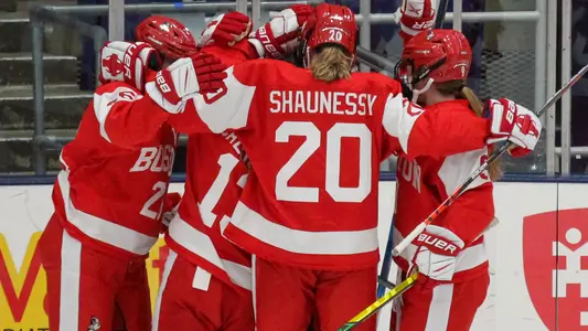 Julia Shaunessy and four other Boston University women's ice hockey players celebrate a goal
