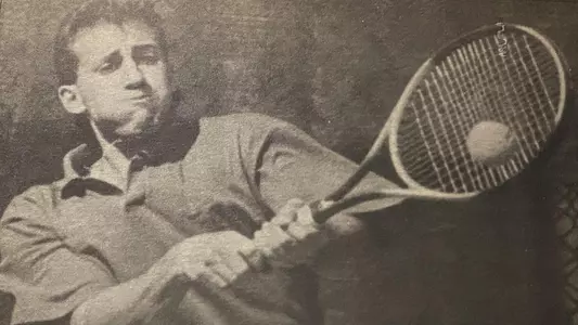Photo of men's tennis alum Pat Gonnelli hitting a ball with a two-handed backhand.